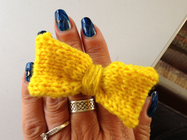 Hand knitted bright yellow bow